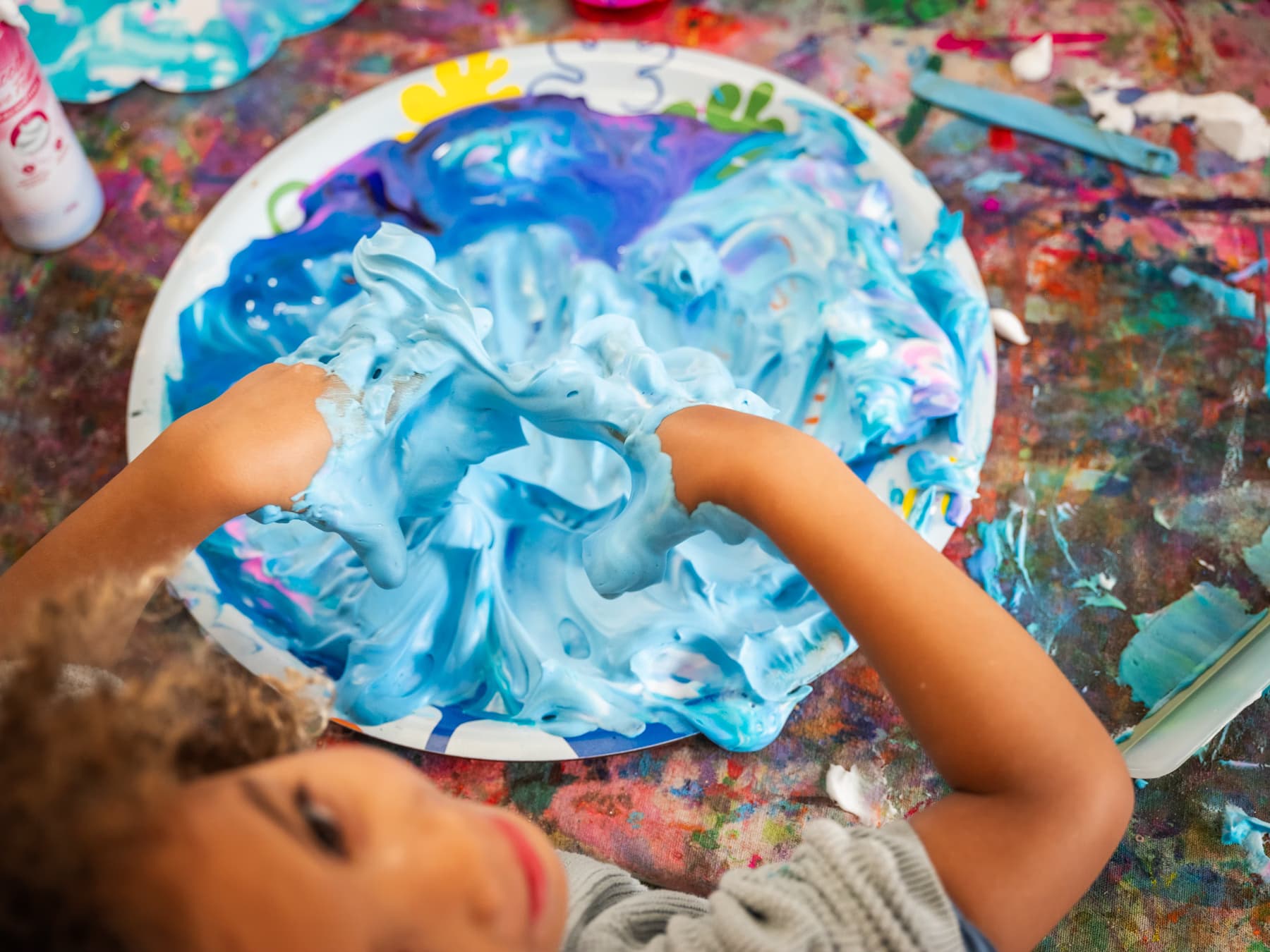 Child exploring blue sensory foam