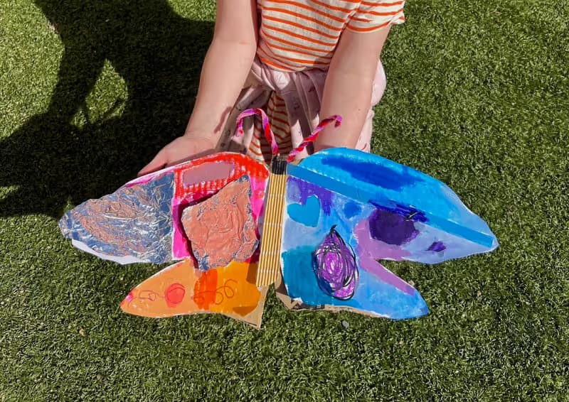 A giant painted cardboard butterfly made at a Smudge party
