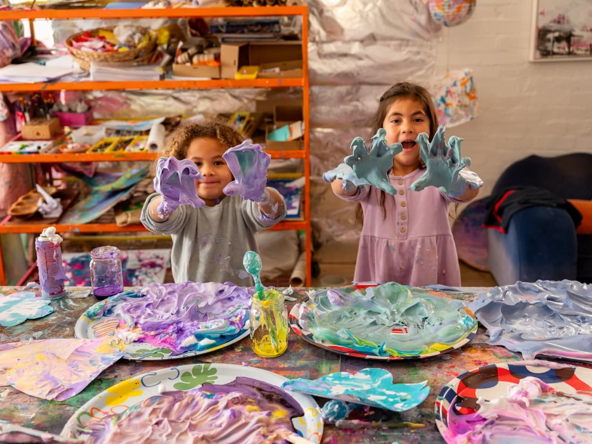 Messy hands covered in colourful paint