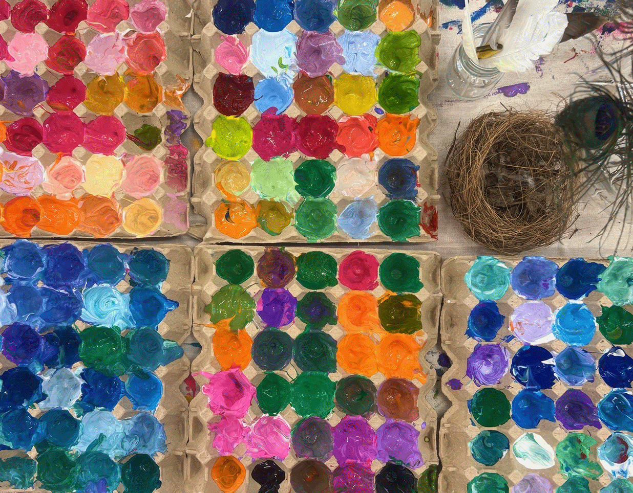 A row of paints set out for an art session.